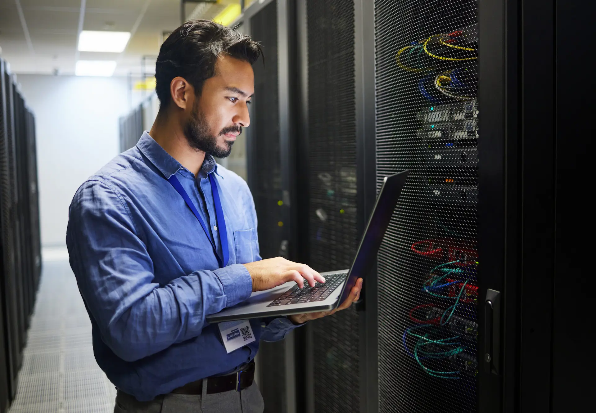IT Worker running diagnostics in server room